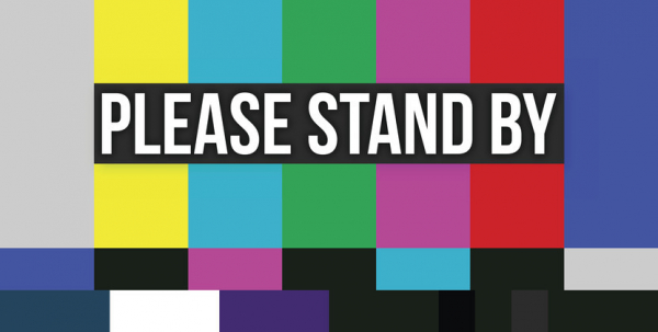image of an error screen used in television transmission, showing vertical bars in various colors with the words please stand by superimposed with white letters in a black box